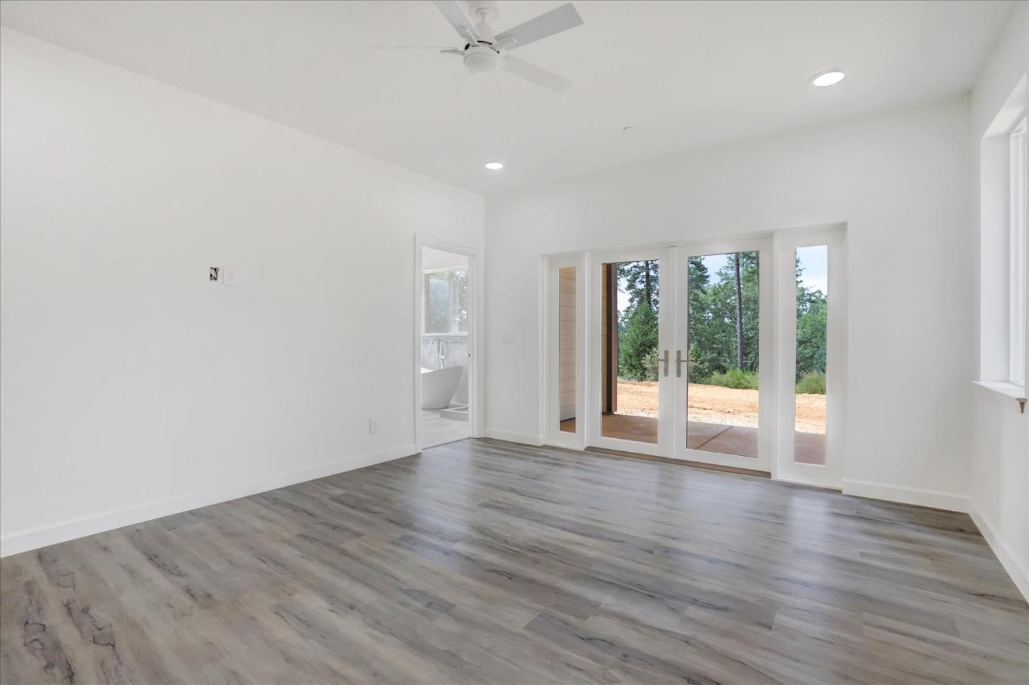10279 Evergreen Ranch Court Grass Valley, CA 95949 - Photo 43 of 79 a view of an empty room with wooden floor and a window
