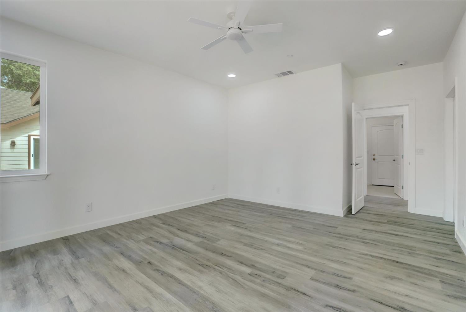 10279 Evergreen Ranch Court Grass Valley, CA 95949 - Photo 44 of 79 an empty room with wooden floor and windows