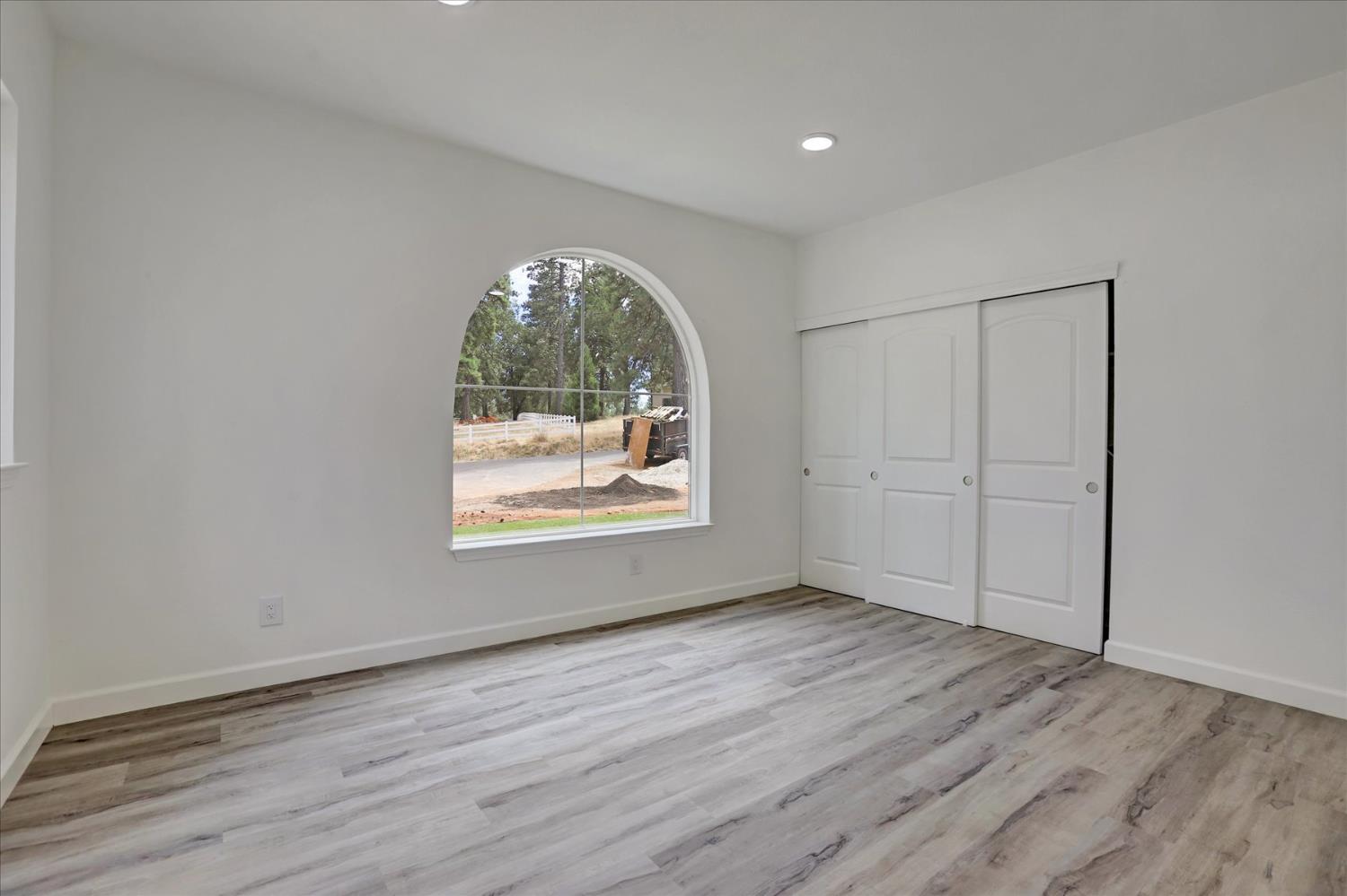 10279 Evergreen Ranch Court Grass Valley, CA 95949 - Photo 52 of 79 an empty room with wooden floor and windows