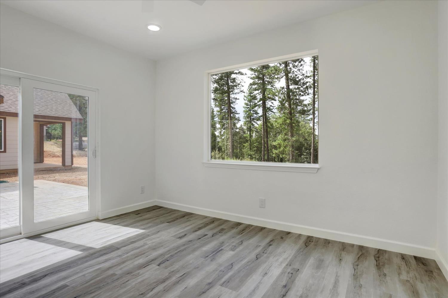 10279 Evergreen Ranch Court Grass Valley, CA 95949 - Photo 58 of 79 an empty room with wooden floor and windows