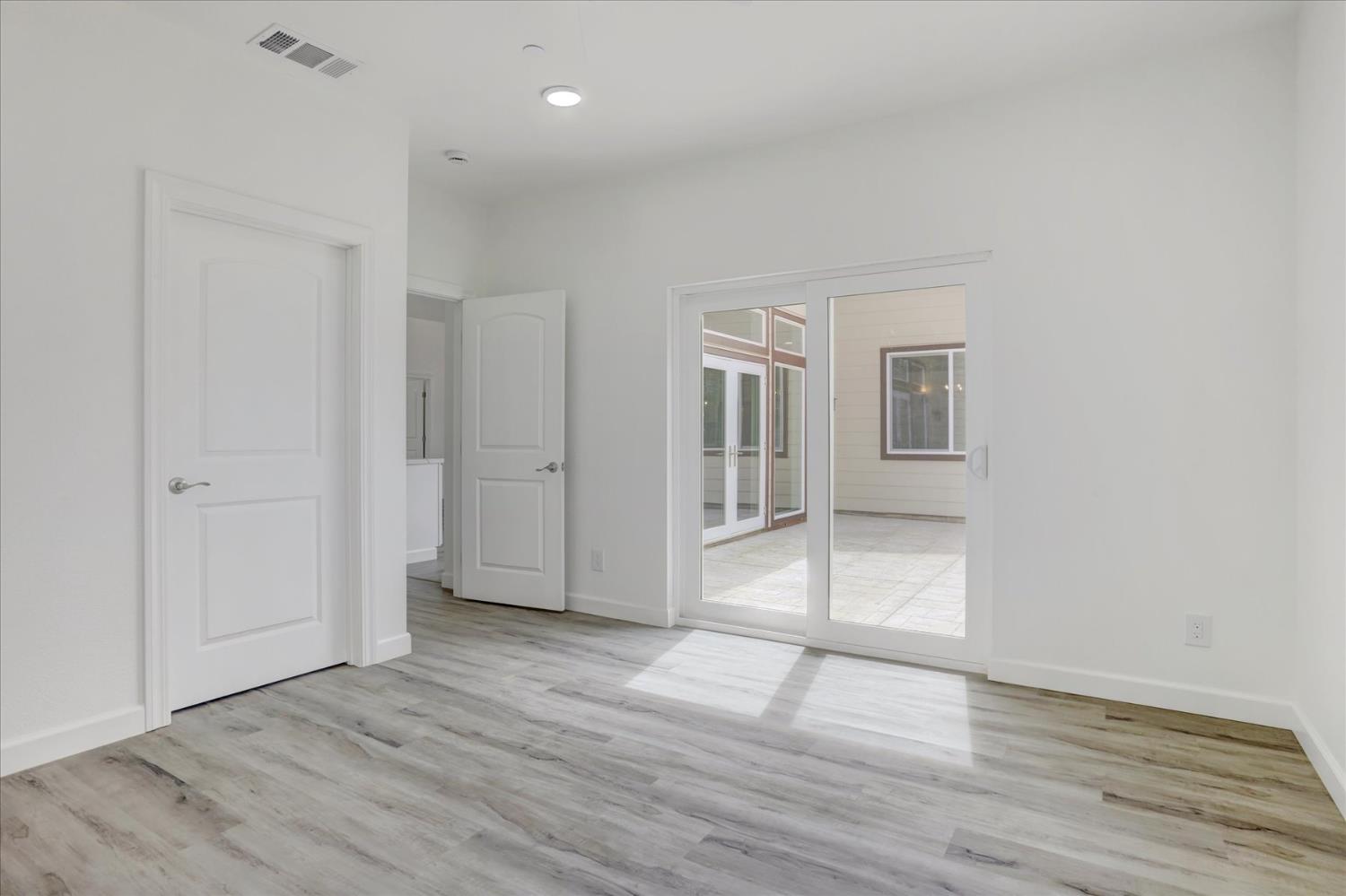 10279 Evergreen Ranch Court Grass Valley, CA 95949 - Photo 59 of 79 an empty room with wooden floor and windows