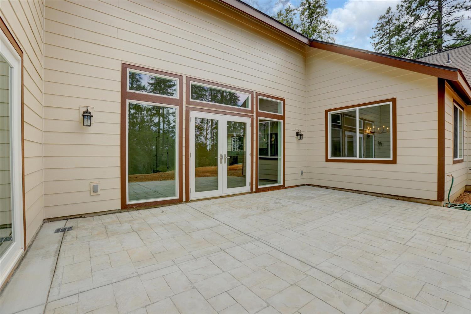 10279 Evergreen Ranch Court Grass Valley, CA 95949 - Photo 76 of 79 a view of a house with a large window and brick walls