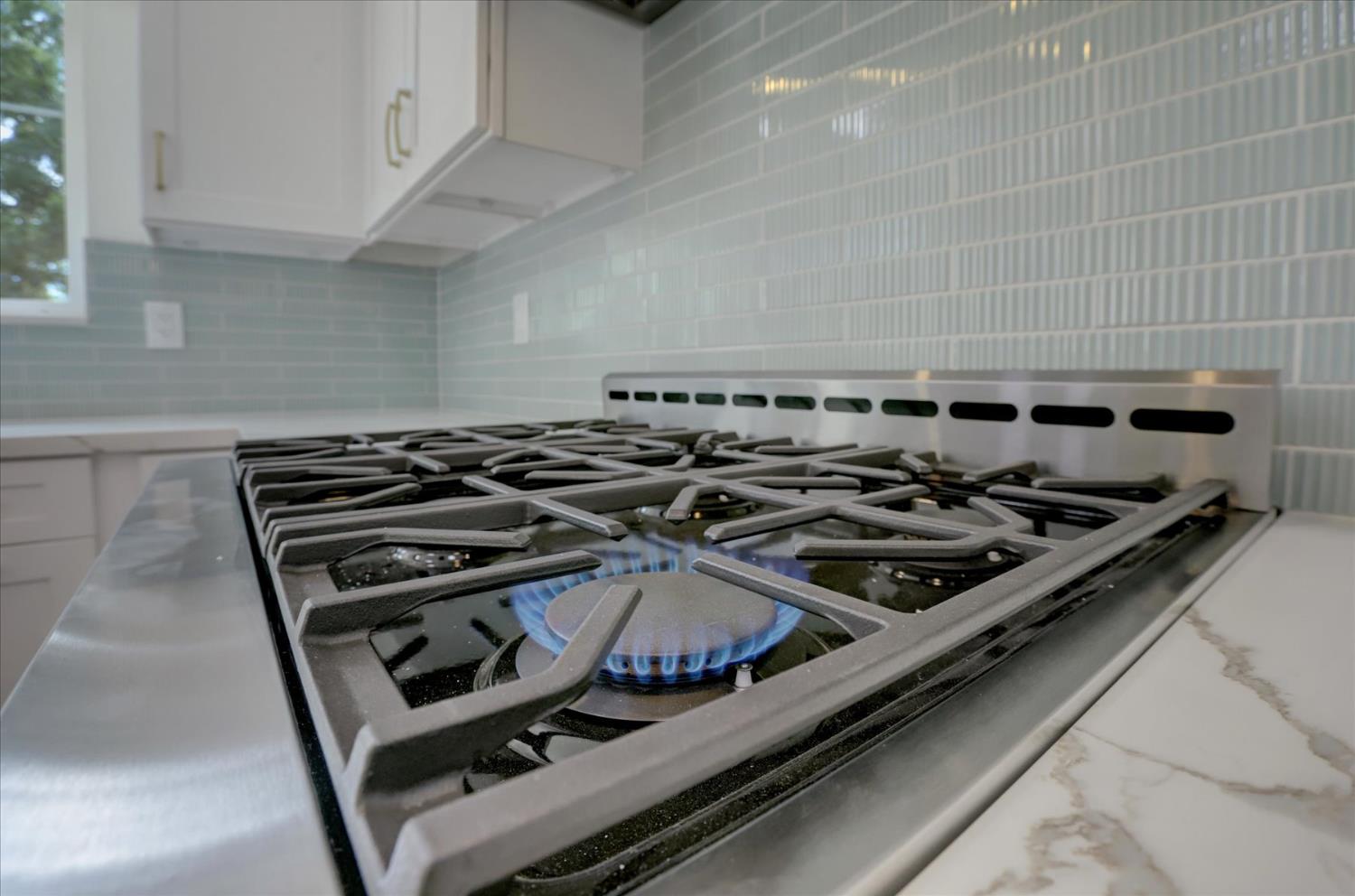 10279 Evergreen Ranch Court Grass Valley, CA 95949 - Photo 8 of 79 a stove sitting inside of a kitchen with white cabinets