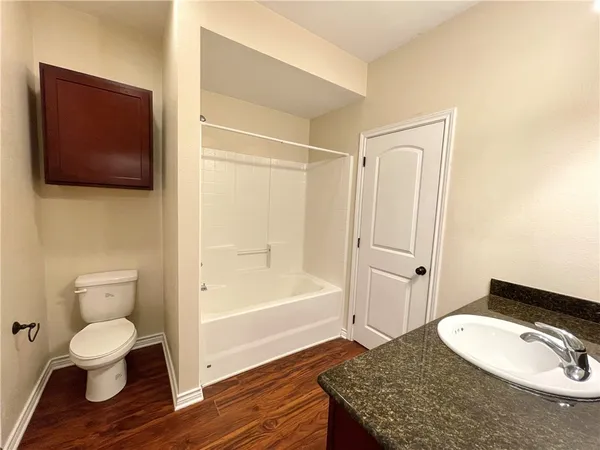 a bathroom with a toilet a sink and bathtub