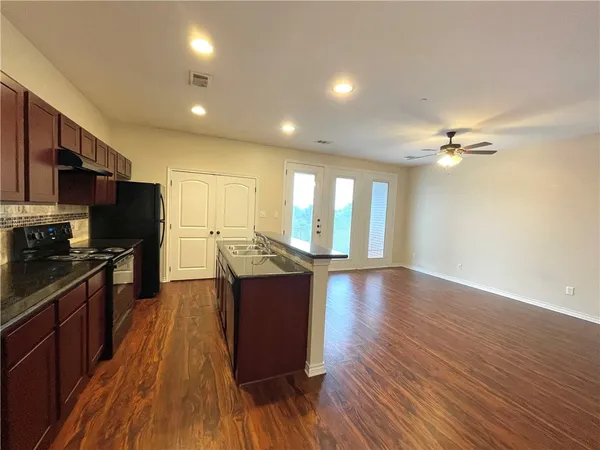 a view of kitchen with sink and wooden floor