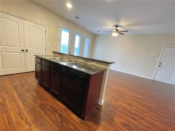 a kitchen with stainless steel appliances granite countertop a stove a sink and a refrigerator