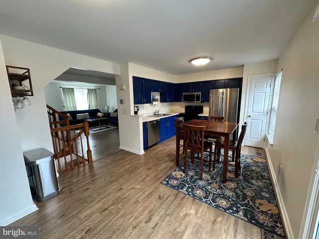 a kitchen with stainless steel appliances granite countertop a refrigerator stove microwave and sink