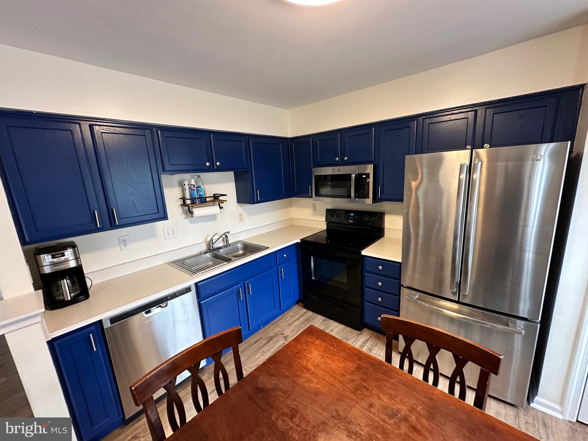 22 Carper Street Bear, DE 19701 - Photo 14 of 56 a kitchen with stainless steel appliances granite countertop a refrigerator stove microwave and sink