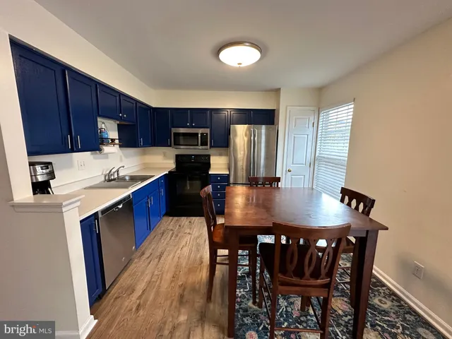 a view of a livingroom with furniture and staircase