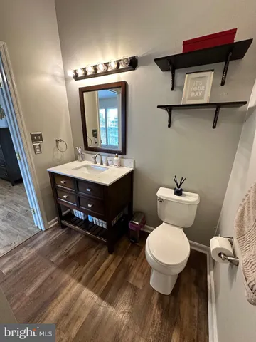 a room with a wooden floor and ceiling fan