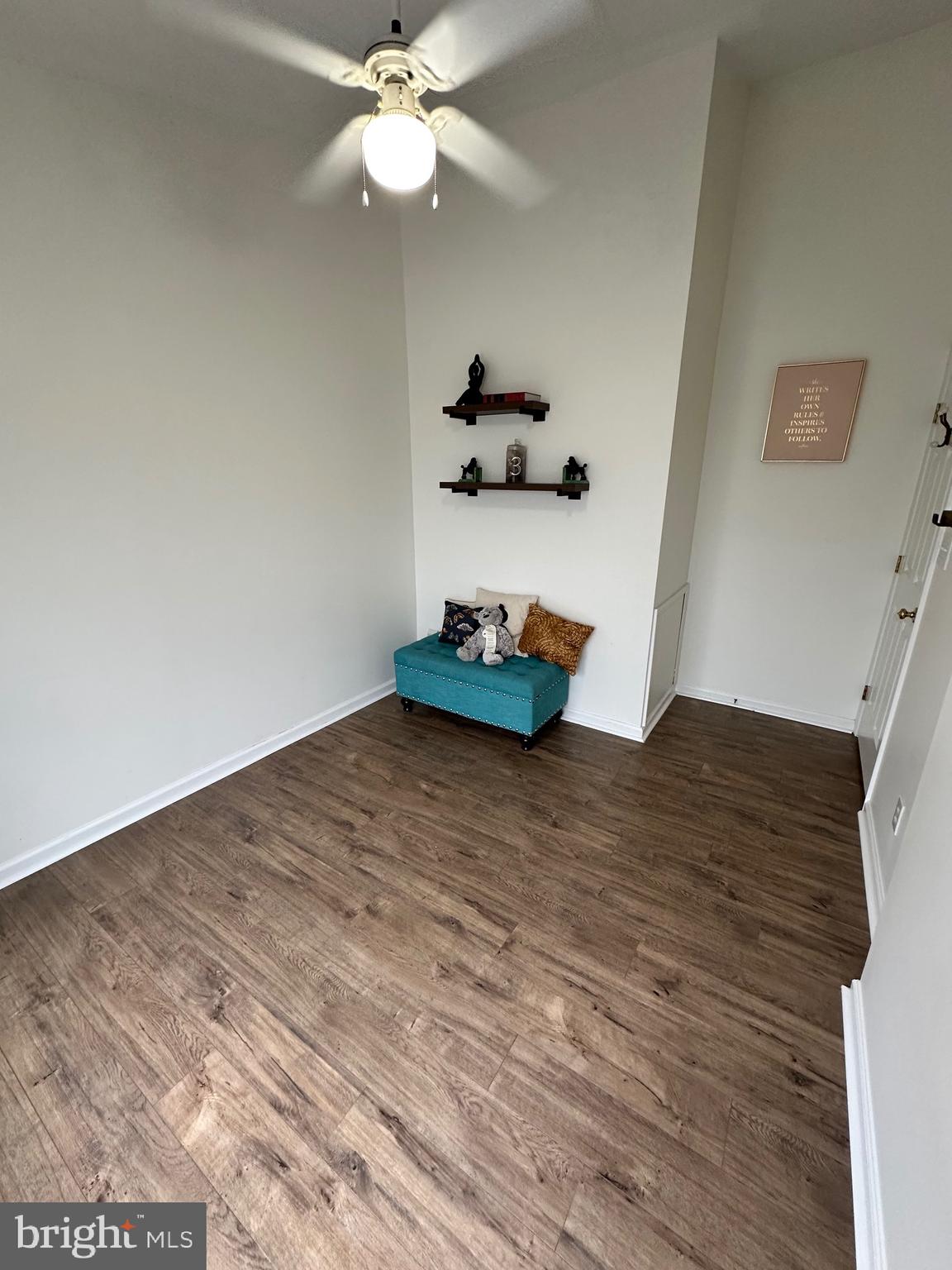 22 Carper Street Bear, DE 19701 - Photo 31 of 56 a room with a wooden floor and ceiling fan