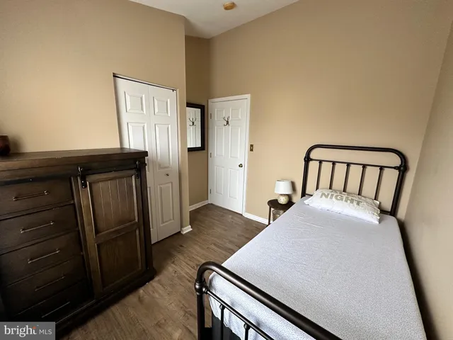 a view of a livingroom with wooden floor and staircase