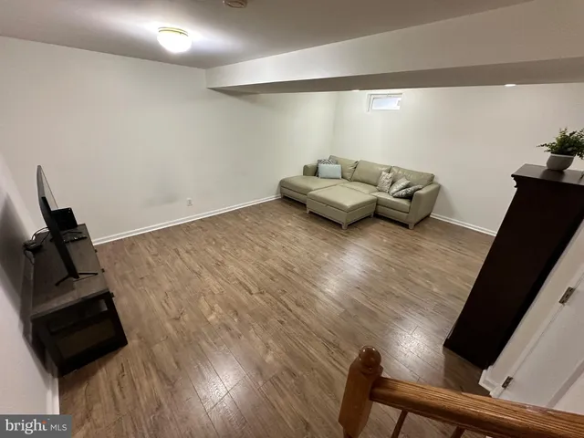 a room with wooden floor and a window