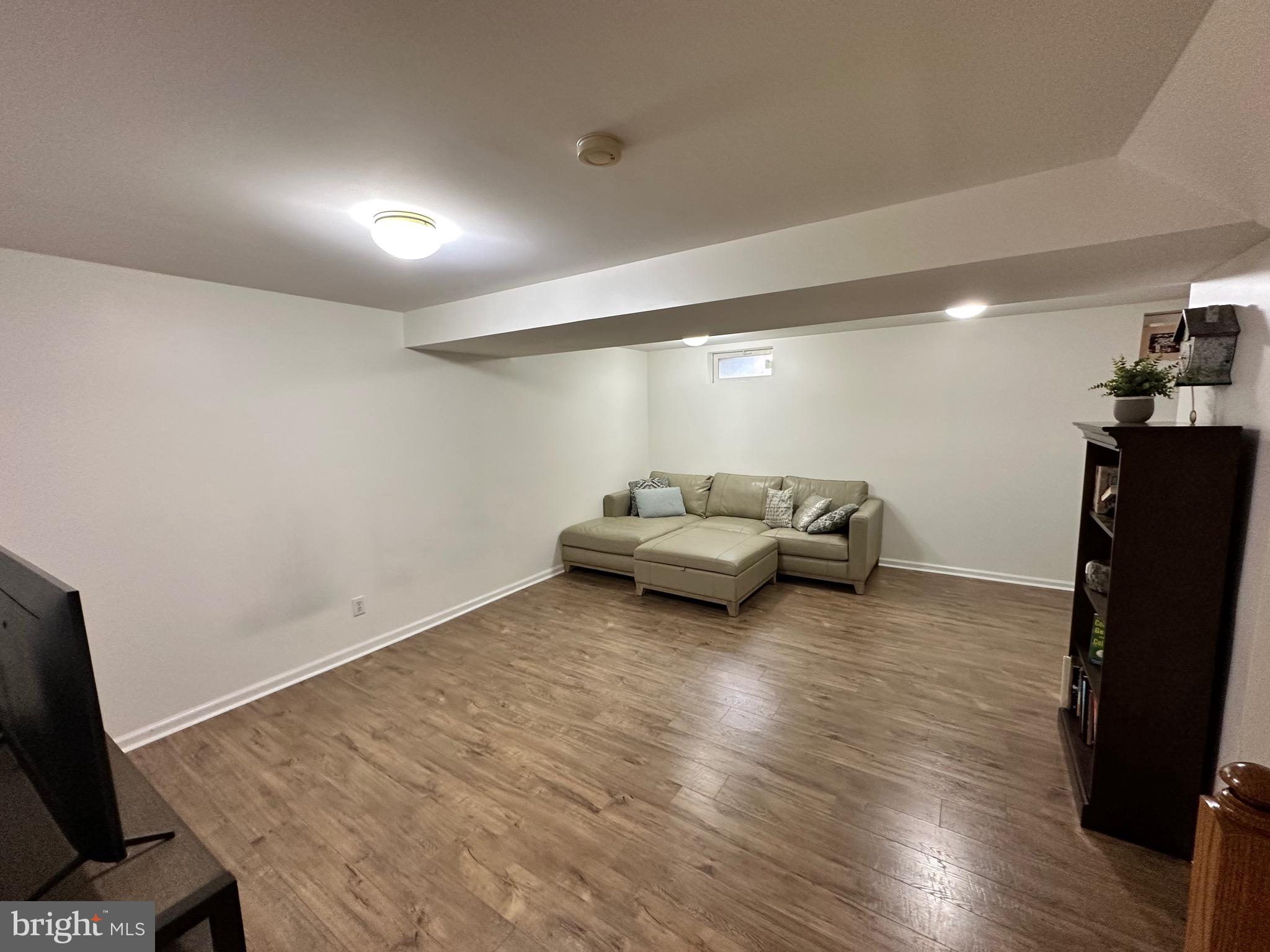 22 Carper Street Bear, DE 19701 - Photo 39 of 56 a living room with furniture and a flat screen tv
