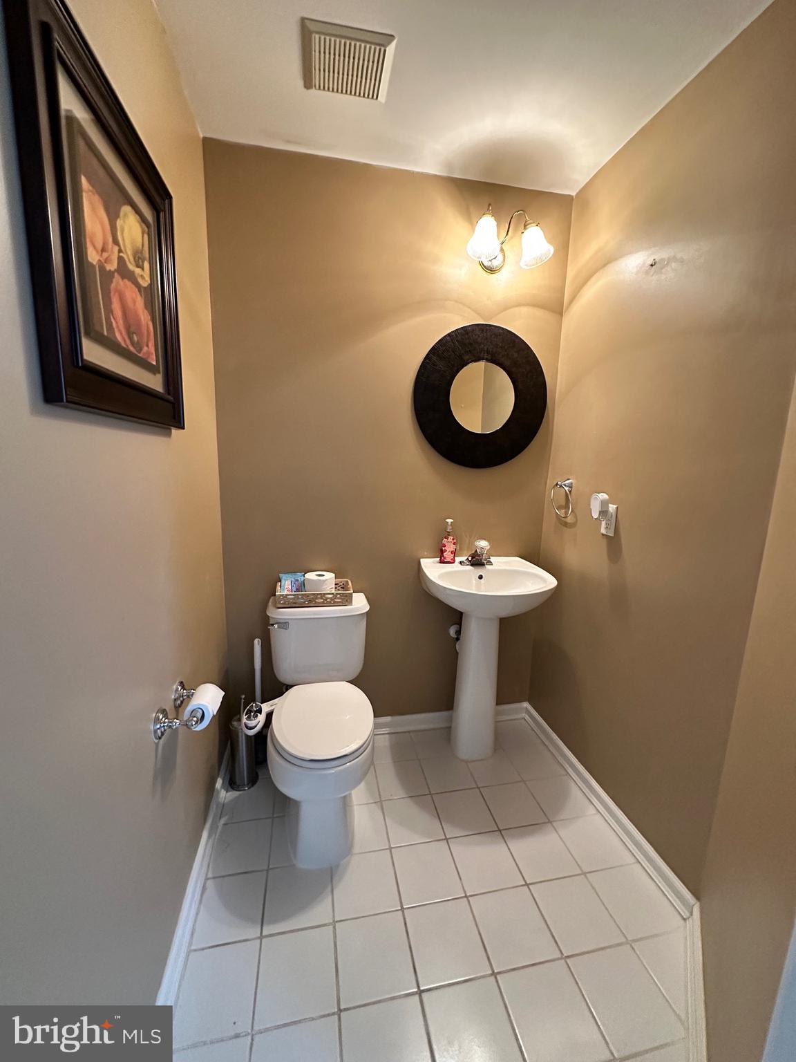 22 Carper Street Bear, DE 19701 - Photo 10 of 56 a bathroom with a toilet sink and mirror