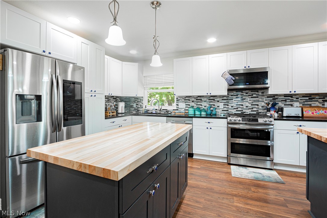 2055 Ganyard Road Akron, OH 44313 - Photo 12 of 49 Kitchen with appliances with stainless steel finishes, backsplash, white cabinets, and wooden counters