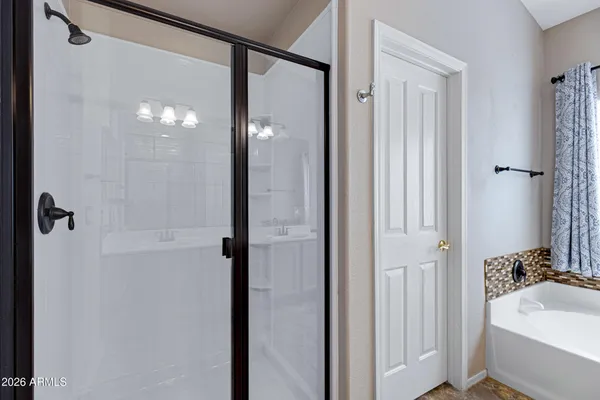 a bathroom with a tub and shower