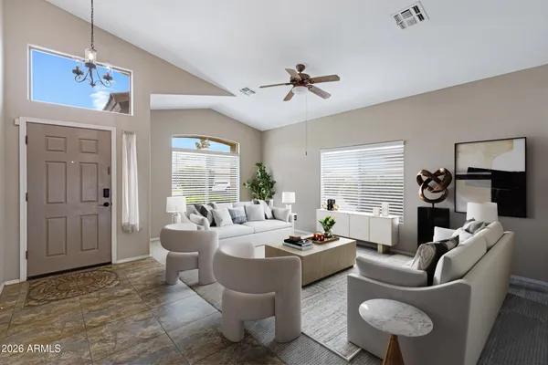 a living room with furniture ceiling fan and a window