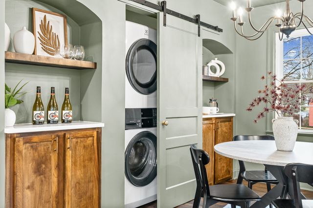 a view of a dining room with furniture and a chandelier