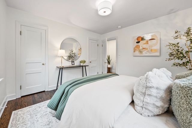 a bedroom with a bed and a painting on the wall