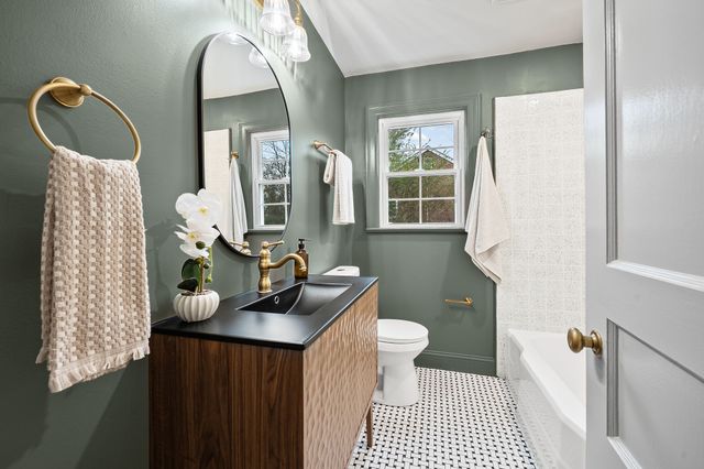 a bathroom with a sink a toilet and a mirror