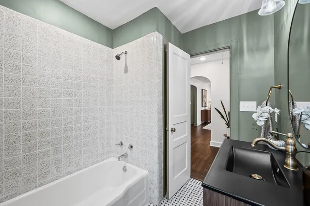 a bathroom with a tub and shower