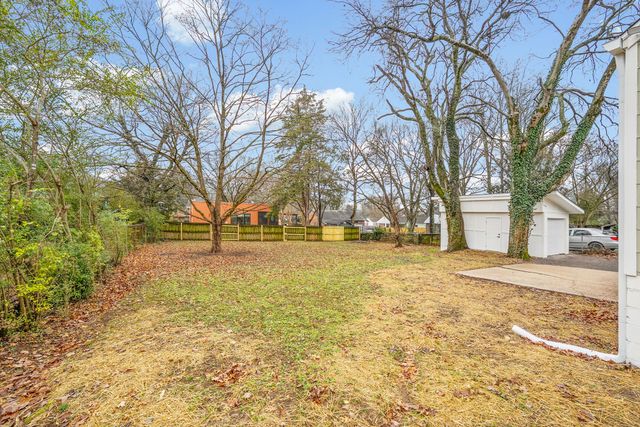 a view of road with large trees