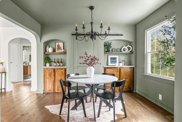 a dining room with furniture a window and wooden floor