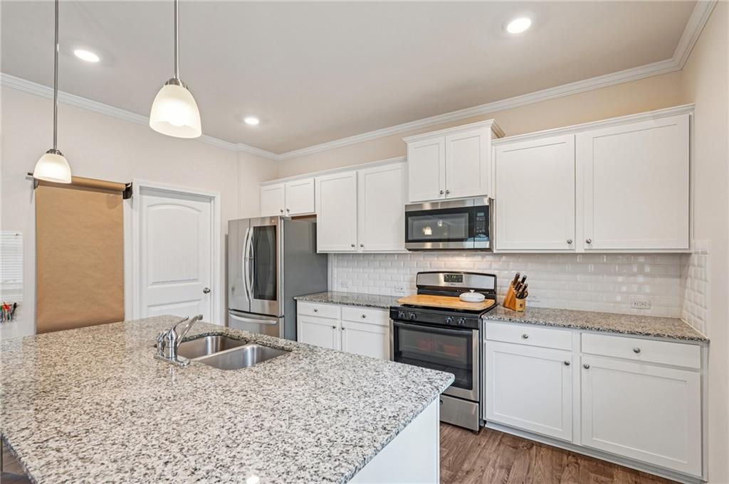 88 Cool Creek Court Dallas, GA 30132 - Photo 16 of 41 a kitchen with stainless steel appliances granite countertop a sink refrigerator and cabinets