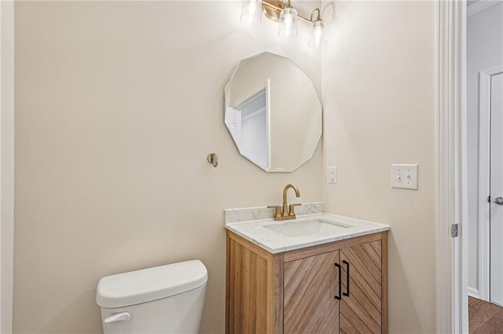 88 Cool Creek Court Dallas, GA 30132 - Photo 22 of 41 a bathroom with a toilet a sink and mirror