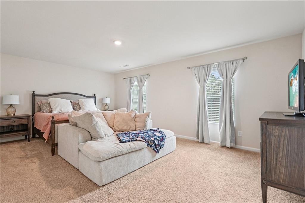 88 Cool Creek Court Dallas, GA 30132 - Photo 23 of 41 a bedroom with a bed and a mirror