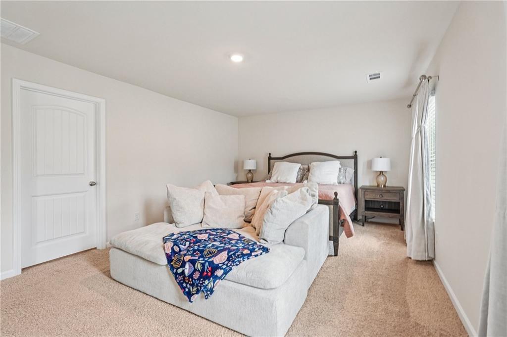 88 Cool Creek Court Dallas, GA 30132 - Photo 24 of 41 a bedroom with a bed and a lamp