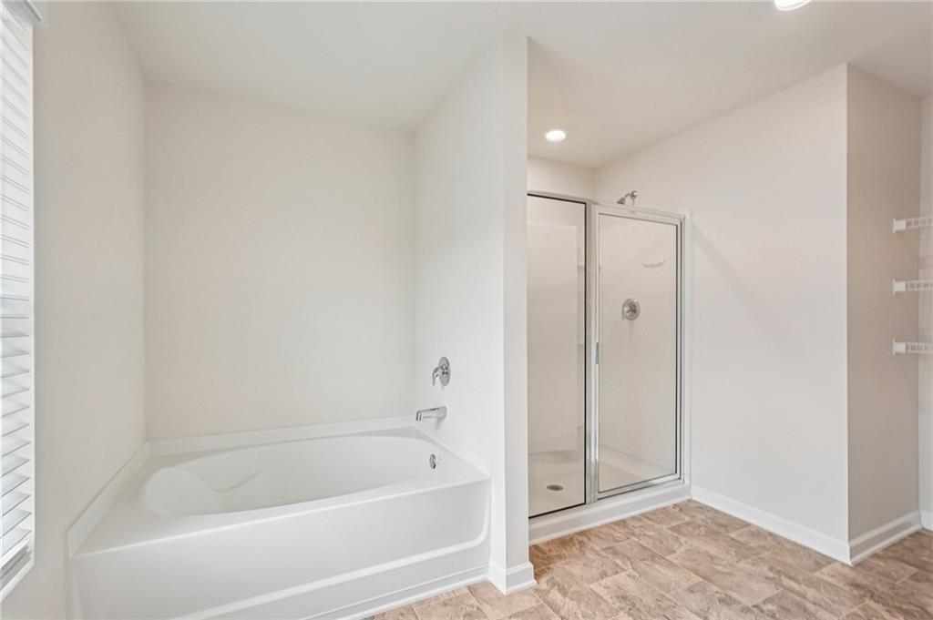 88 Cool Creek Court Dallas, GA 30132 - Photo 27 of 41 a bathroom with a bathtub and a shower
