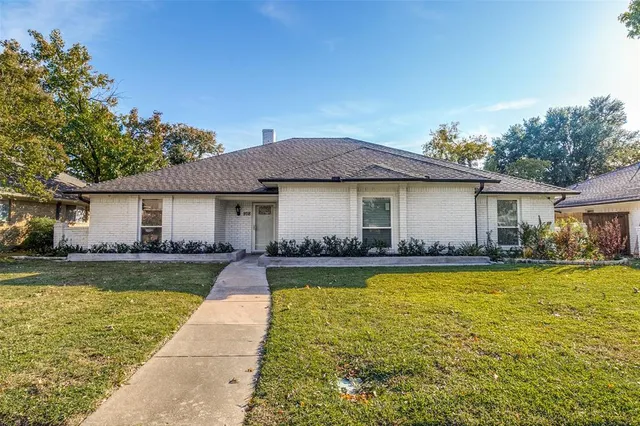 a front view of a house with swimming pool having outdoor seating