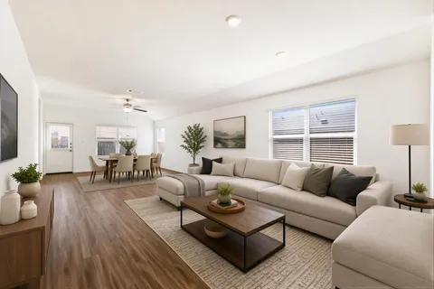 a living room with furniture and wooden floor