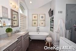 1051 Oceanfront, Unit 7 Long Beach, NY 11561 - Photo 11 of 15 a bathroom with a sink and a mirror