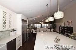a large kitchen with a lot of counter space and a chandelier