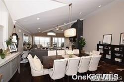 1051 Oceanfront, Unit 7 Long Beach, NY 11561 - Photo 9 of 15 a living room with furniture a window and kitchen view