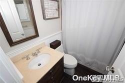1051 Oceanfront, Unit 7 Long Beach, NY 11561 - Photo 10 of 15 a bathroom with a sink and a mirror