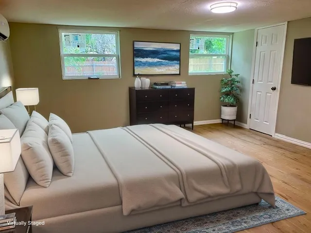 a bedroom with a bed and a window