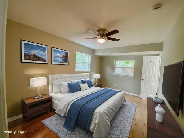 a bedroom with a bed and a flat screen tv