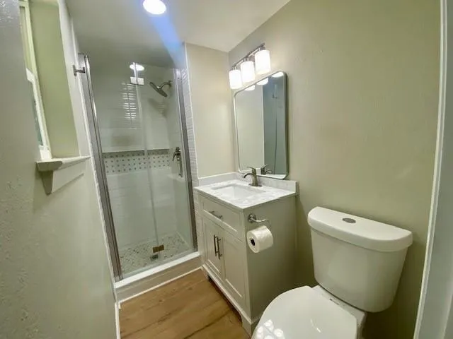 a bathroom with a toilet a sink and a mirror