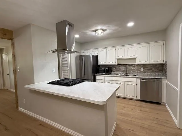 a kitchen with a sink stove and refrigerator