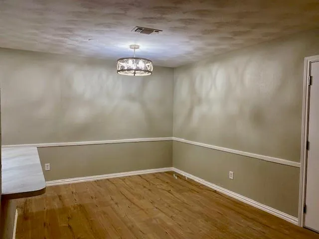 a view of a small space with wooden floor