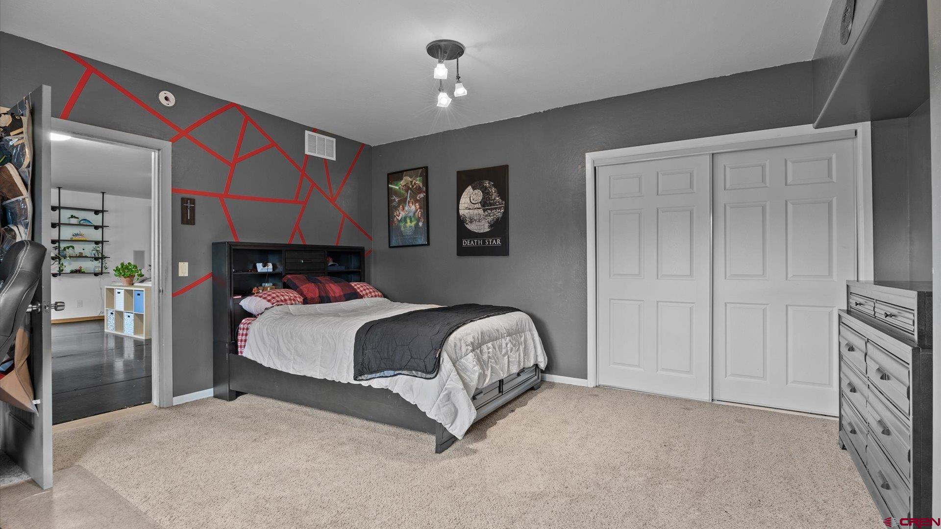 20866 Trophy Road Montrose, CO 81403 - Photo 19 of 29 a bedroom with a bed and a painting on the wall