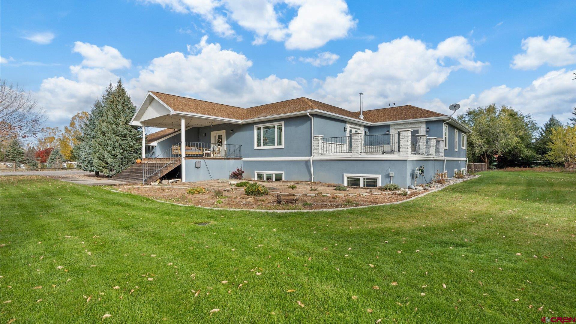 20866 Trophy Road Montrose, CO 81403 - Photo 24 of 29 a view of a house with a backyard and sitting area