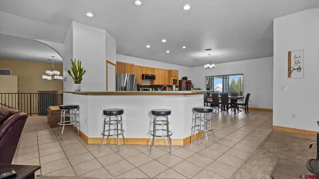 a living room with furniture a dining table and kitchen view