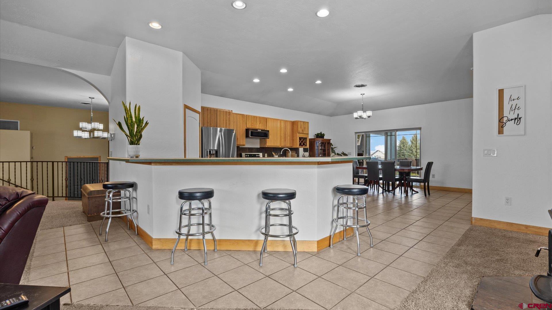20866 Trophy Road Montrose, CO 81403 - Photo 5 of 29 a living room with furniture a dining table and kitchen view