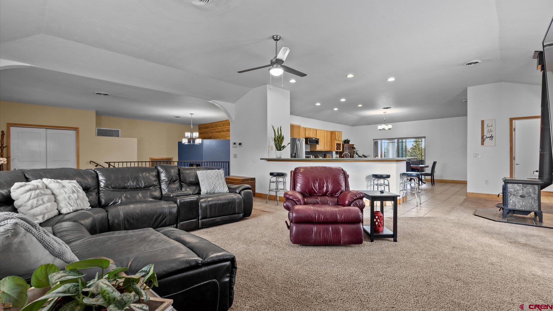 20866 Trophy Road Montrose, CO 81403 - Photo 7 of 29 a living room with furniture and a chandelier