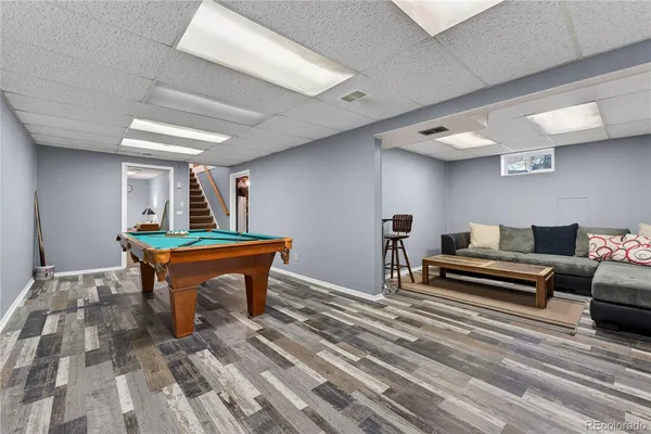 a bedroom with furniture and a wooden floor